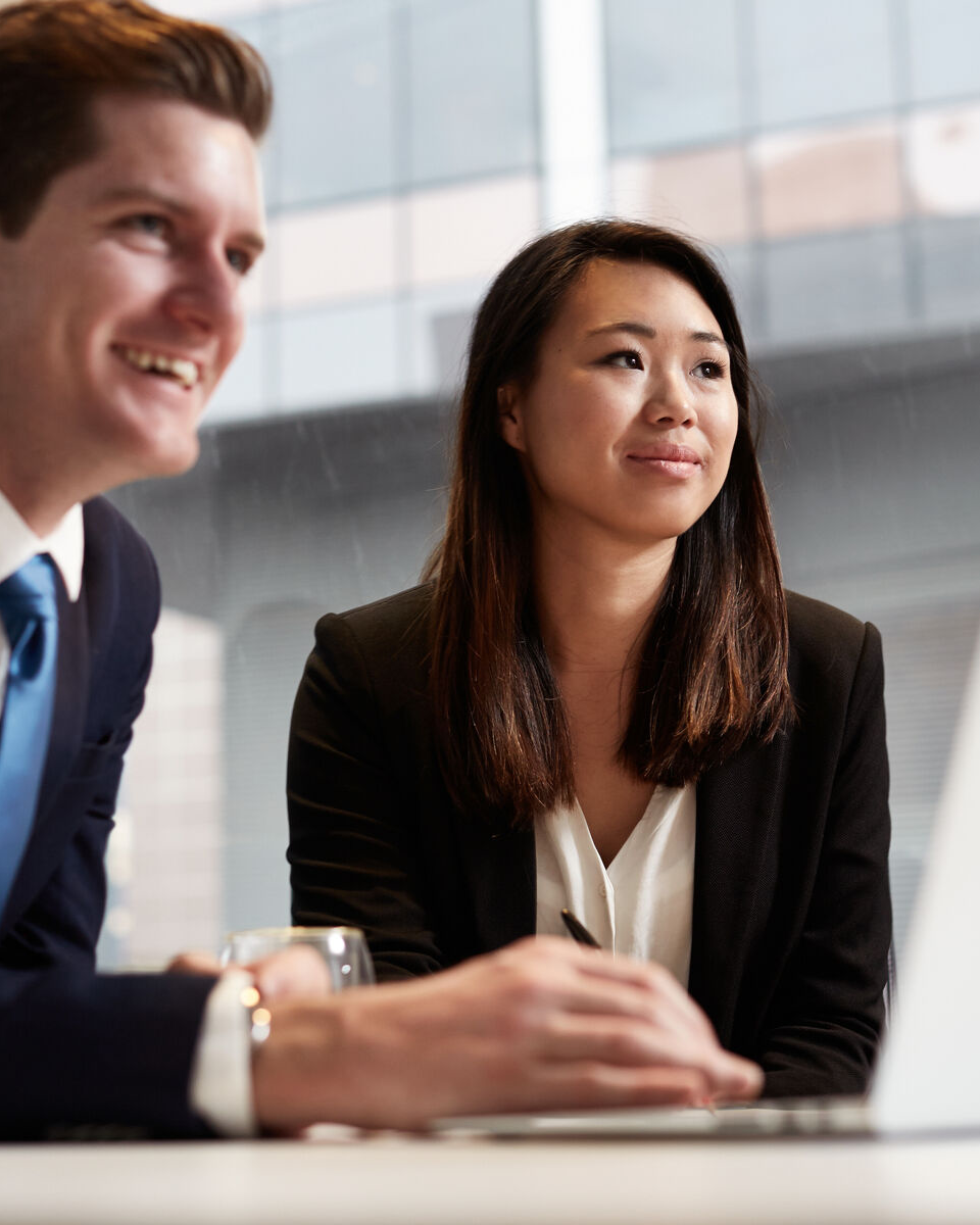 Man and woman looking at a laptop
