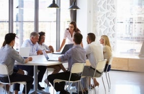 A group of businesspeople around an office table.
