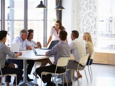 A group of businesspeople around an office table.